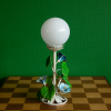 Hand painted table lamp with blue flowers, green leaves and an opaline globe from France 1950s