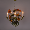 A lovely floral chandelier with red roses and green leaves. This metal chandelier is made in Italy and is from the 1950s.